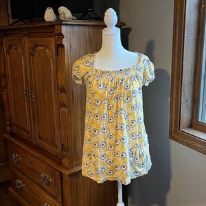 Baby doll shirt. Fun print. Elastic gathered at neckline. 2 pockets in front.